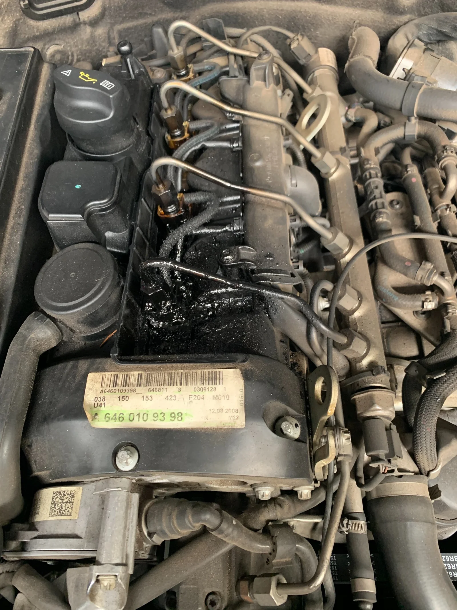 Mercedes 220CDI diesel engine bay showing injector seal leak and carbon buildup
