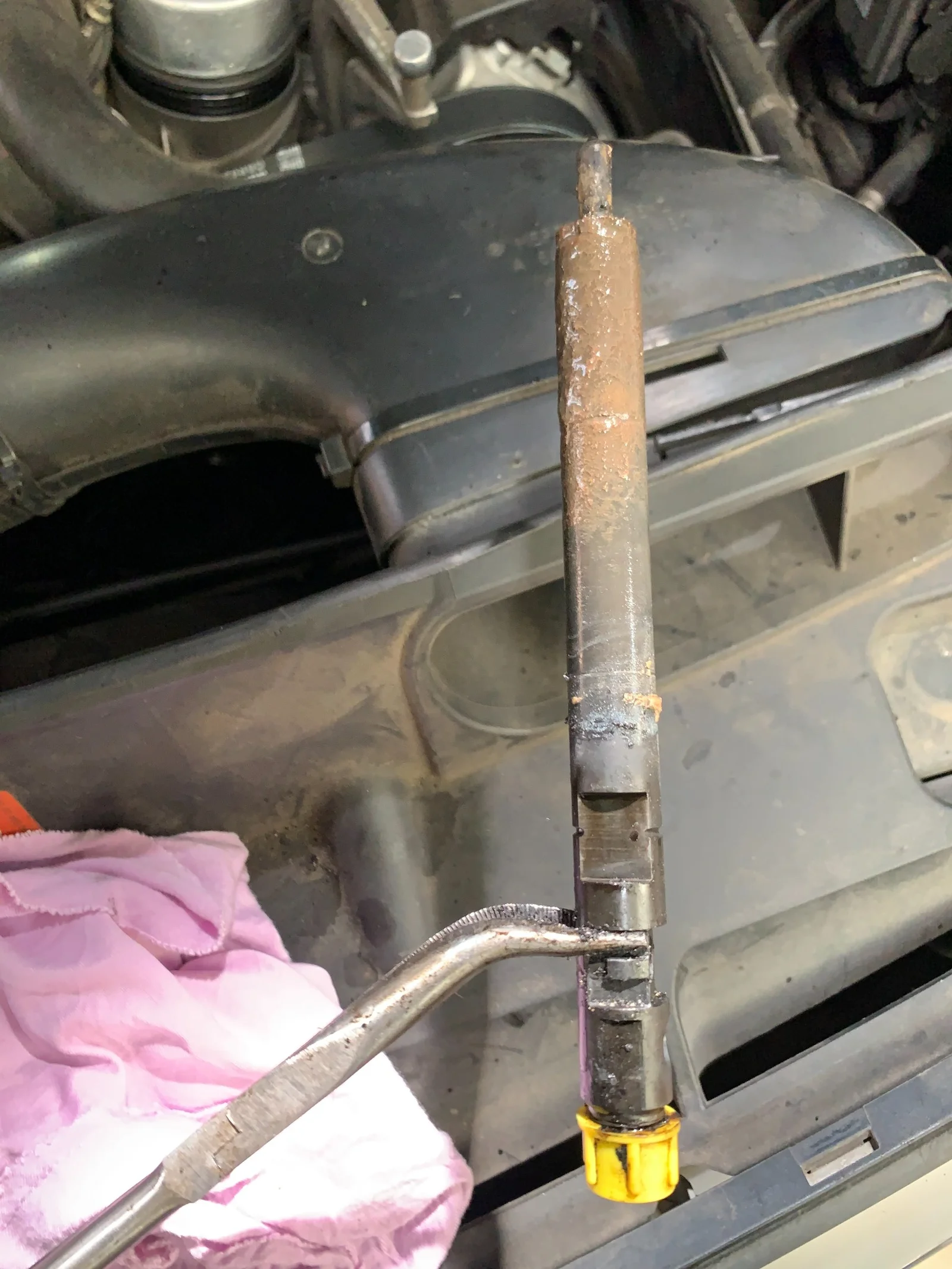 Worn diesel injector removed from Mercedes 220CDI showing corrosion and deposits