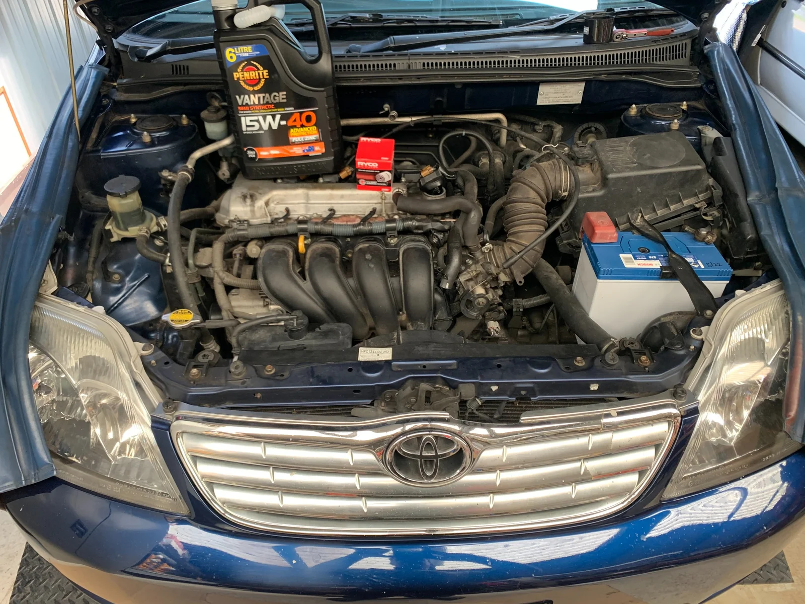 Toyota Corolla engine bay with Penrite Vantage 15W-40 oil and Ryco filter ready for service