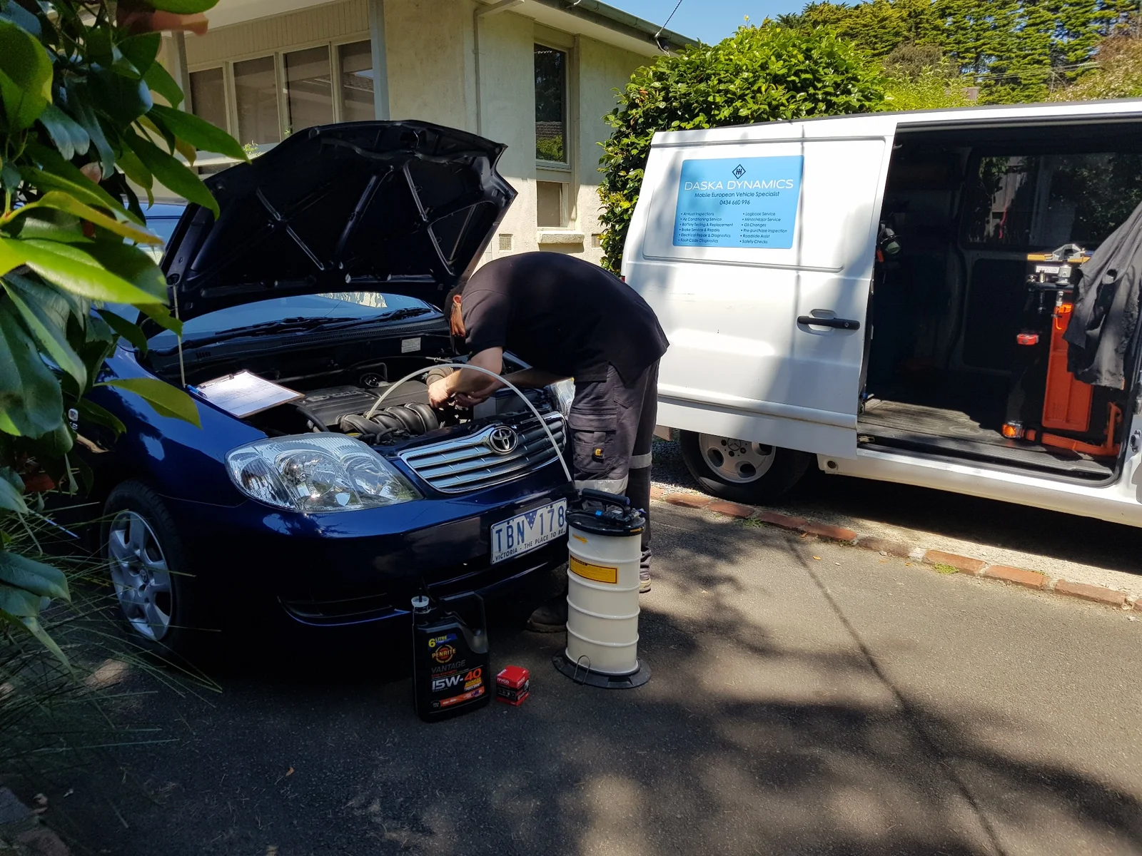 Mobile mechanic performing oil change on Toyota Corolla using Penrite oil