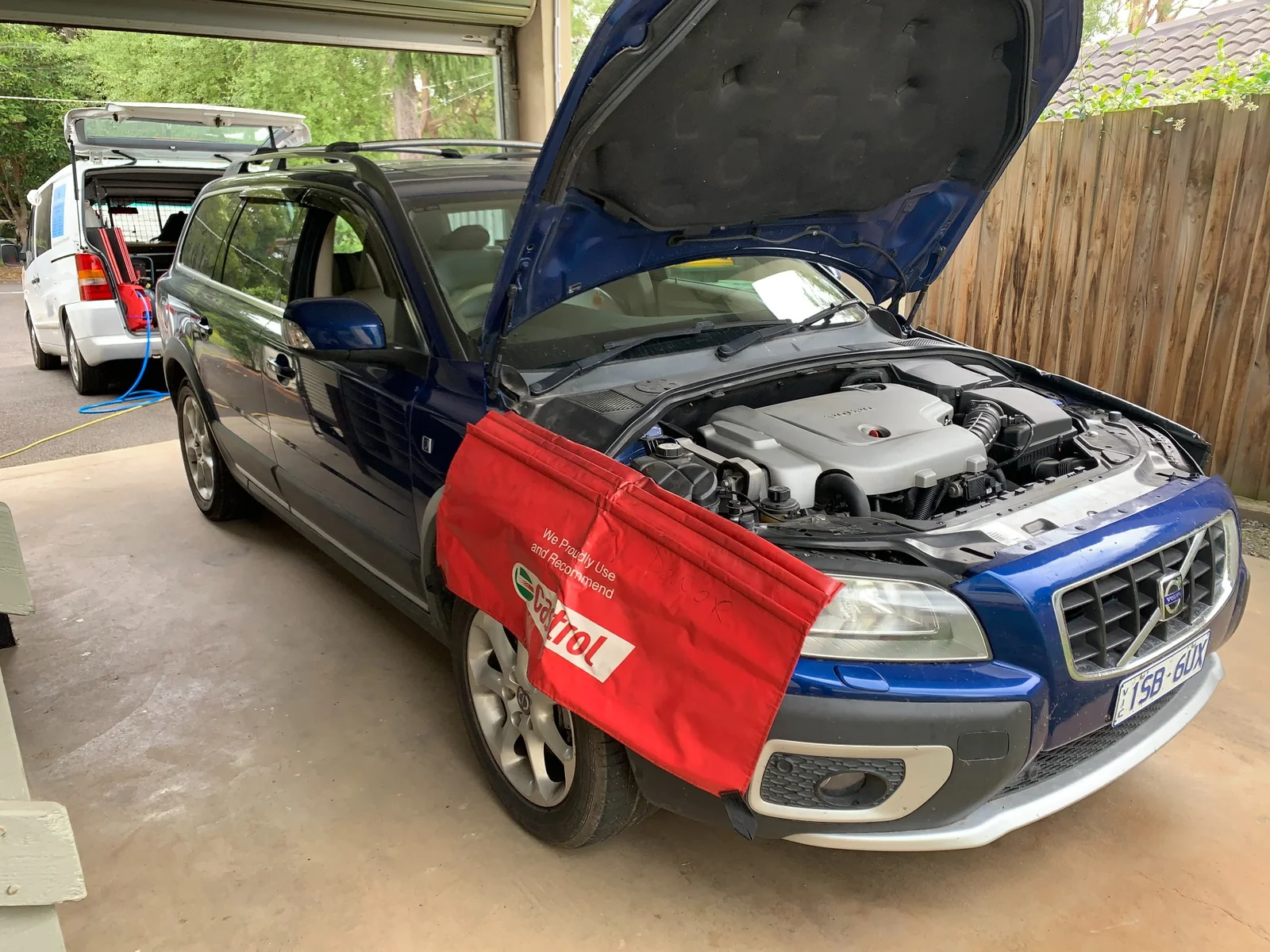 Volvo C70 in workshop with Castrol fender cover during engine service